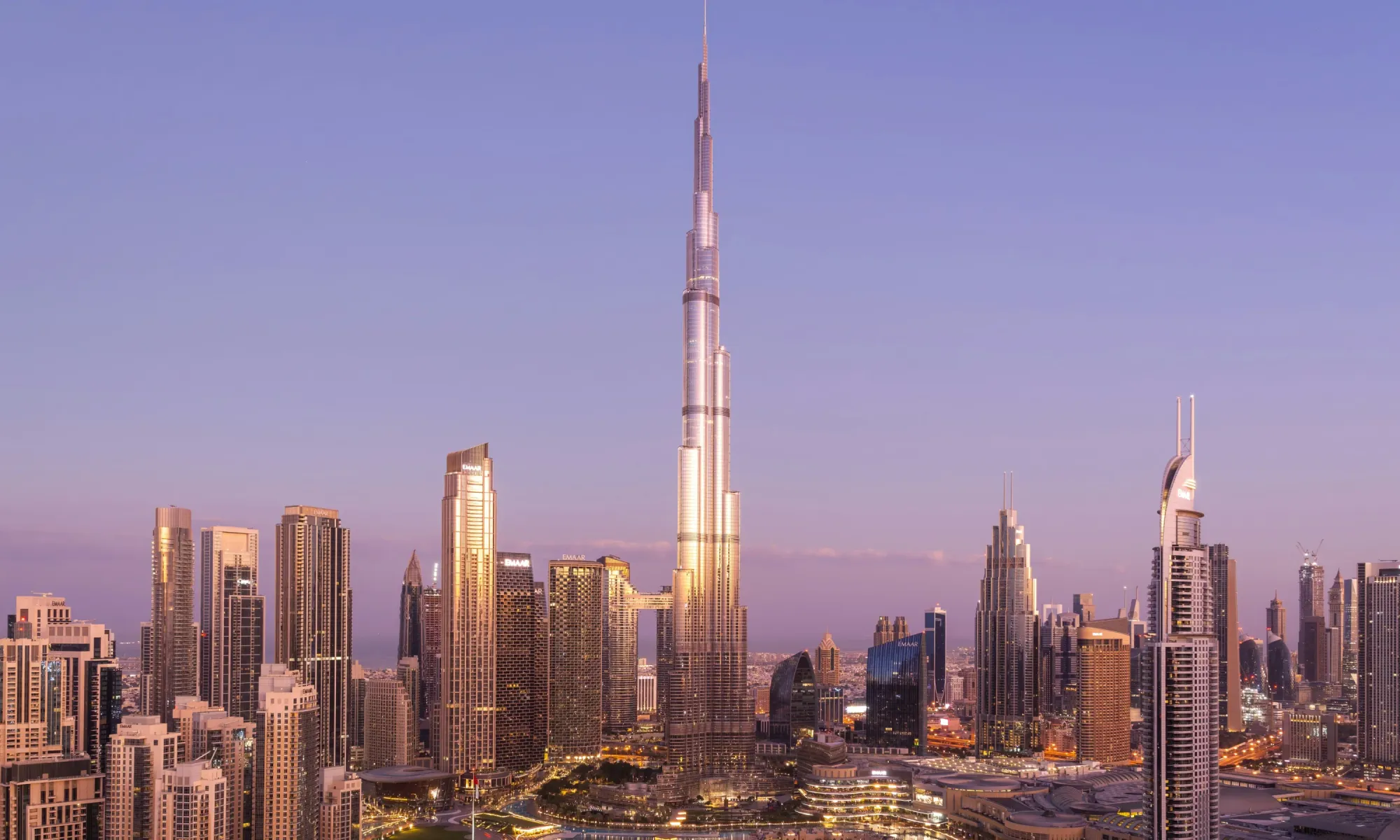 Futuristic Dubai skyline with glowing blockchain tokens overlaying luxury real estate properties, symbolizing real estate tokenization and fractional ownership on RWA platforms in 2026