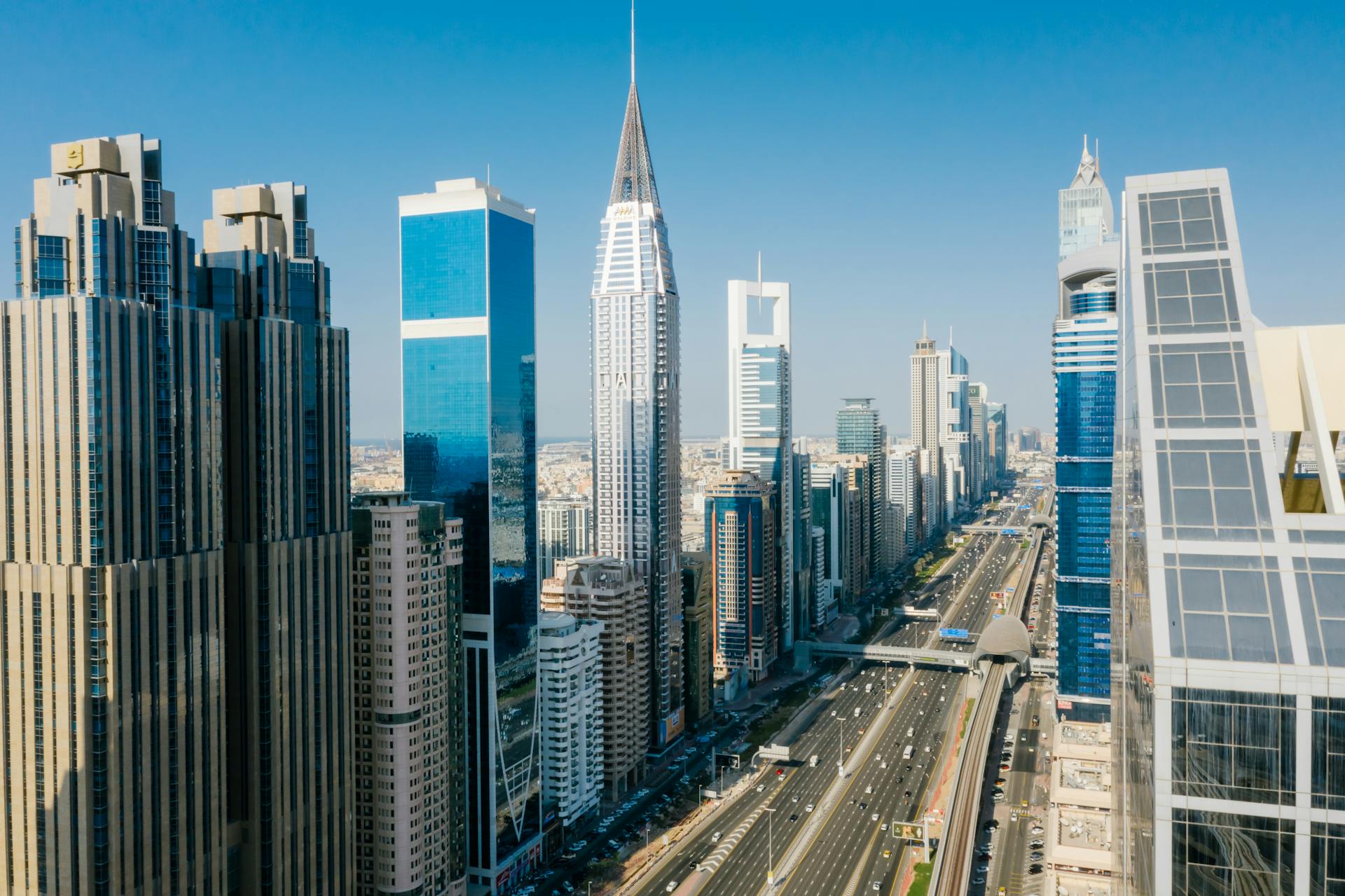 Aerial view of Dubai skyline with blockchain overlay symbolizing UAE tokenized real estate growth and New York City properties for fractional ownership in $392M on-chain market